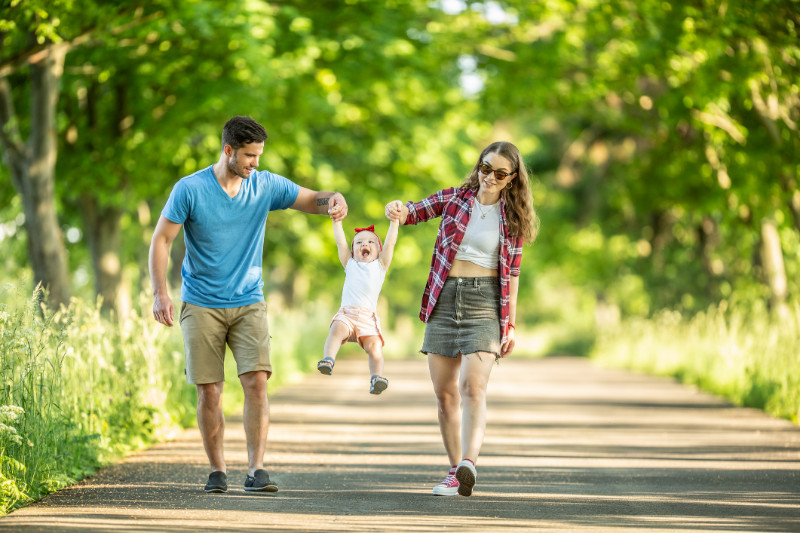 A happy family walking in a park